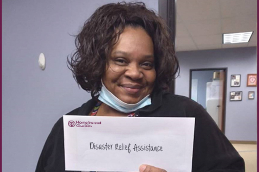 Caregiver holds disaster relief envelope