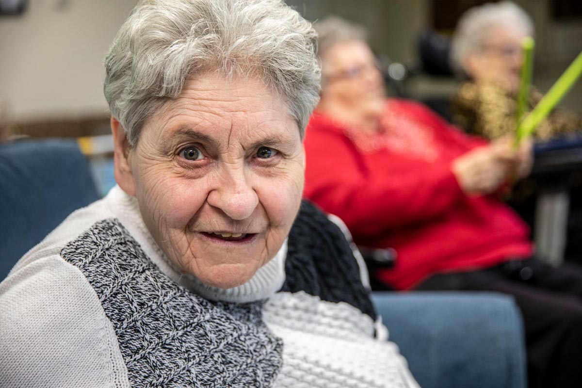 Elderly woman turns and smiles